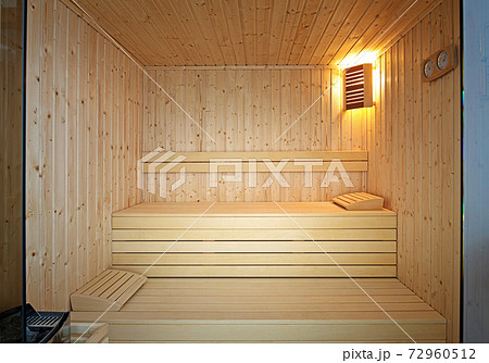 Front view of traditional Finnish sauna room. Empty interior of wooden spa cabin with hot dry steam 72960512