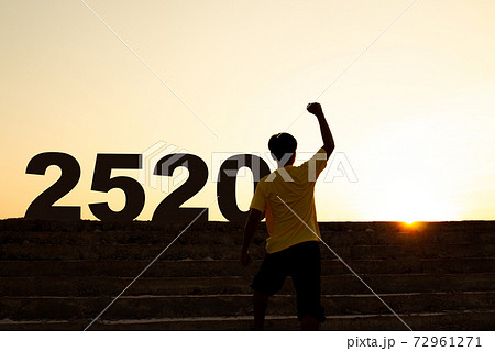 Entering 2020, young man stepping up the concrete stairs, Ambitions concept and Successful. 72961271