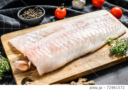 Fresh Raw Cod loin fillet with thyme. Black background. Top view Fresh Raw Cod loin fillet with thyme. Black background. Top view 72961572