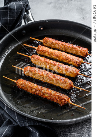 Turkish and Arabic Traditional kebab, ground beef, lamb meat. White background. Top view Turkish and Arabic Traditional kebab, ground beef, lamb meat. White background. Top view 72961691
