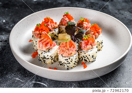 Sushi Maki roll with tuna, salmon and caviar. Black background. Top view Sushi Maki roll with tuna, salmon and caviar. Black background. Top view 72962170
