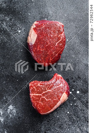 Raw beef meat steak Tenderloin fillet. Black background. Top view Raw beef meat steak Tenderloin fillet. Black background. Top view 72962544