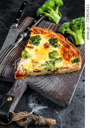Pie quiche with red fish salmon and broccoli. Black background. Top view 72962611