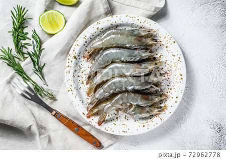 Fresh raw giant langoustine shrimp on a white plate. Gray background. Top view. Copy space Fresh raw giant langoustine shrimp on a white plate. Gray background. Top view. Copy space 72962778
