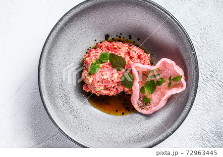 Salmon tartare with avocado and red caviar. White background. Top view. Salmon tartare with avocado and red caviar. White background. Top view. 72963445