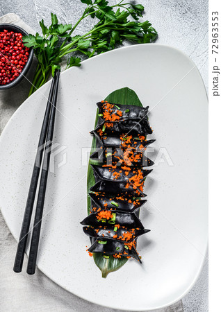 Black Dim sum dumplings. Asian cuisine. Gray background. Top view Black Dim sum dumplings. Asian cuisine. Gray background. Top view 72963553