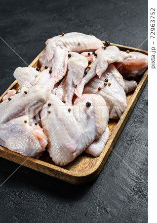 Raw chicken wings. Farm organic poultry. Top view. Black background. Raw chicken wings. Farm organic poultry. Top view. Black background. 72963752
