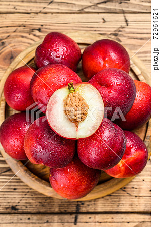 Tray of Fresh red nectarines. Wooden background. Tray of Fresh red nectarines. Wooden background. 72964624