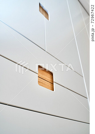 Modern wardrobe with finger pull design. Wooden wardrobe with light gray cabinet doors. Modern furniture Modern wardrobe with finger pull design. Wooden wardrobe with light gray cabinet doors. Modern furniture 72967422