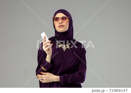 Beautiful arab woman posing in stylish hijab isolated on studio background. Fashion concept 72969147
