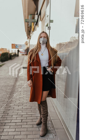 woman in protective medical mask kn95 respirator on street woman in protective medical mask kn95 respirator on street 72969636