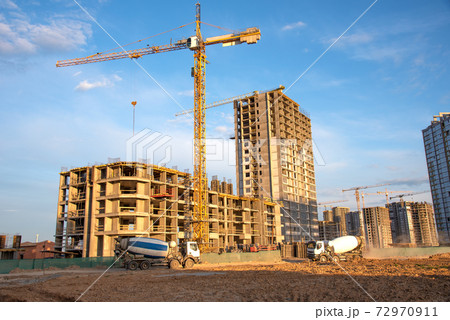 Heavy mixer concrete truck for to be loaded concrete at a construction site. Heavy mixer concrete truck for to be loaded concrete at a construction site. 72970911