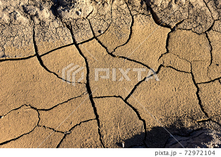 Dry lake or swamp in the process of drought and lack of rain or moisture, a global natural disaster Dry lake or swamp in the process of drought and lack of rain or moisture, a global natural disaster 72972104