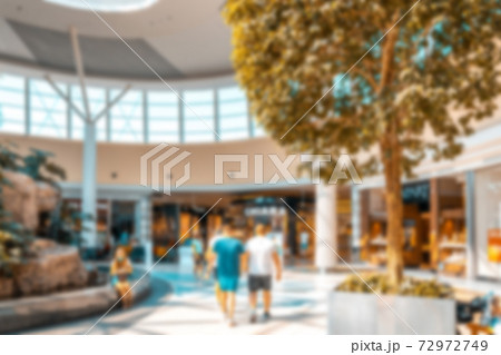 Young people shopping mall blurred background. Interior of retail centre store in soft focus. People shopping in modern commercial mall center. Fashion market hall. Young people shopping mall blurred background. Interior of retail centre store in soft focus. People shopping in modern commercial mall center. Fashion market hall. 72972749