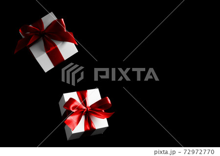 Present online. White gifts with red bow falling on black background for Black Friday banner. Flying backdrop with space for text. 72972770