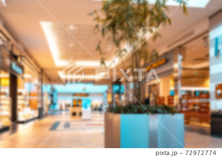 Shopping mall interior blurred background. People shopping in modern commercial mall center. Interior of retail centre store in soft focus. Image for background use. 72972774