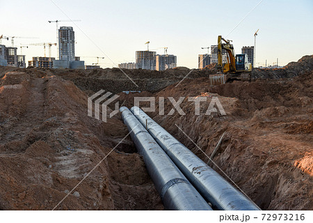 Excavator during construction of main water supply pipeline. Laying underground storm sewers 72973216