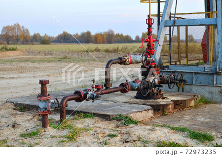 Industrial piping with steel flanges and bolts on oil field. Industrial piping with steel flanges and bolts on oil field. 72973235
