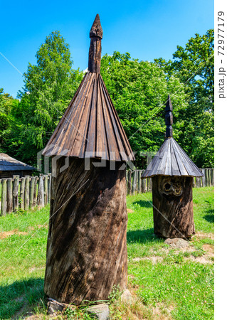 Ancient wooden beehives in old rural apiary 72977179