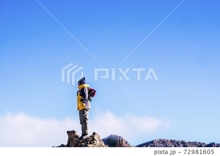 People enjoying the outdoor leisure ativity with sport hiking lifestyle - man standing on the top of the mountains looking at the blue sky - clear background success and travel concept 72981605