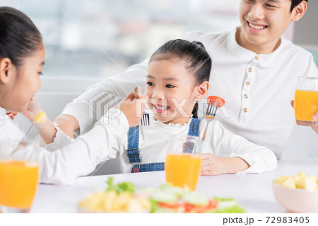 Family eating breakfast 72983405