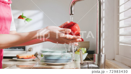 Asian housewife wash fruit Asian housewife wash fruit 72983430