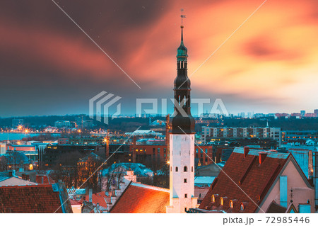 Tallinn, Estonia. Night Sunset Sky Above Traditional Old Architecture Skyline In Old Town. Church Of Holy Ghost Or Holy Spirit In Winter Evening. Famous Landmark And UNESCO Heritage Site. Altered Sky 72985446