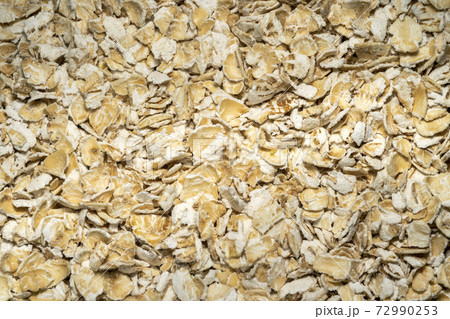 Rolled oat flakes background 72990253