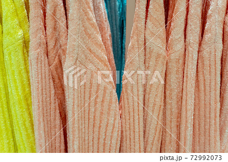 Multicolored sweater clothes hang on a hanger in the mall 72992073