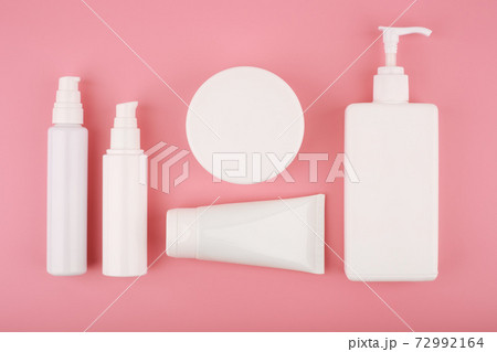 Flat lay with set of cosmetic products on pink background. Concept of beauty and skincare Flat lay with set of cosmetic products on pink background. Concept of beauty and skincare 72992164