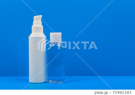 Face cream and lotion on blue table against blue background. Concept of hygiene and skincare with copy space Face cream and lotion on blue table against blue background. Concept of hygiene and skincare with copy space 72992165