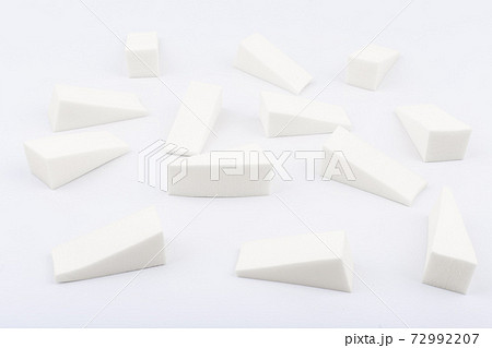 Triangle shaped make up sponges in random order on white background 72992207