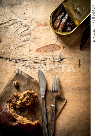 Smoked sprats with rye bread. Smoked sprats with rye bread. 72993427