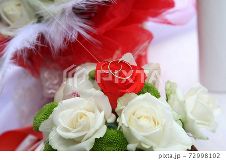 Wedding rings on bride's bouquet 72998102