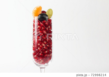pomegranate seeds in the glass on a light background 72998214