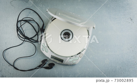 Close up of a vintage portable compact disc player. Close up of a vintage portable compact disc player. 73002895