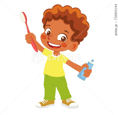 boy holding toothbrush and toothpaste 73004144