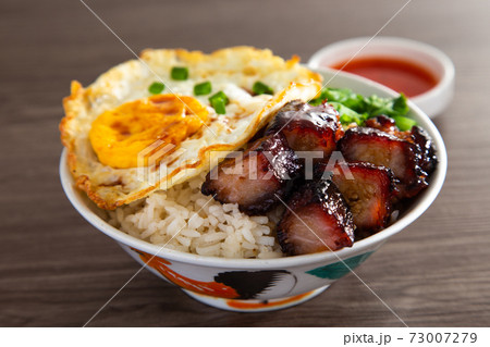 Chinese Sweet Bbq Pork is marinated in a sweet BBQ sauce and served with white rice. Chinese Sweet Bbq Pork is marinated in a sweet BBQ sauce and served with white rice. 73007279