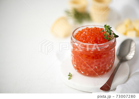 red salmon caviar in a glass jar 73007280