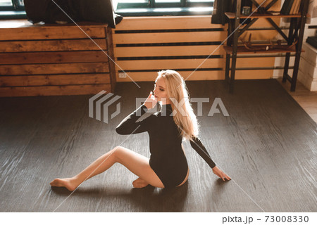 Woman in a black bodysuit. Sensual gorgeous young lady posing in studio Woman in a black bodysuit. Sensual gorgeous young lady posing in studio 73008330