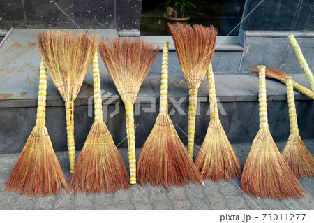 Sale of straw brooms on the Yerevan street 73011277