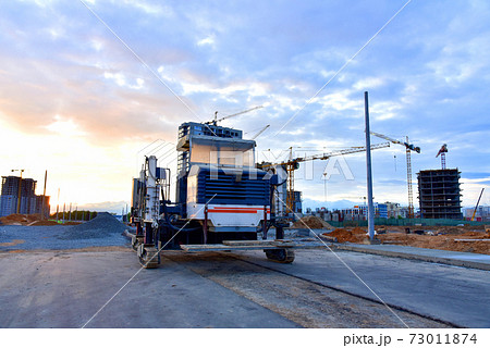 Slipform paver machine on road work at construction site. Highway concrete paving 73011874