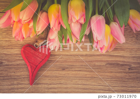 bouquet of multicolored tulip flowers with heart 73011970