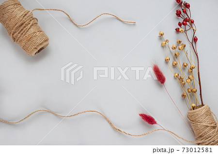 Frame with linen or cannabis jute rolls for making natural body jute washclothes, or washclothes for dishes, on light grey background with copyspace for text. Handmade DIY and hobby concept 73012581