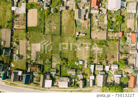 Belarus, Europe. Aerial View Of Small Town, Village Cityscape Skyline In Summer Day. Residential District, Houses And Vegetable Garden Beds In Bird's-eye View 73013227