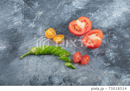 Close up photo of organic sliced vegetables. Tomato, green pepper Close up photo of organic sliced vegetables. Tomato, green pepper 73018514
