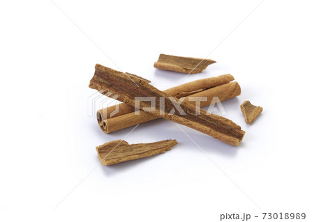 A heap of cinnamon sticks on white background A heap of cinnamon sticks on white background 73018989