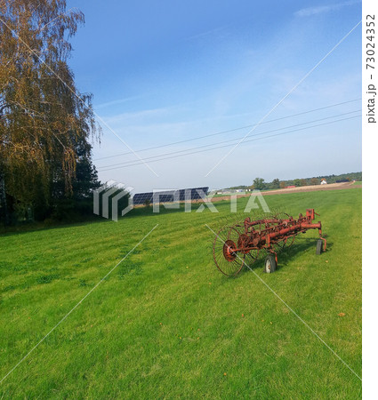 solar panels in green rural village yard 73024352
