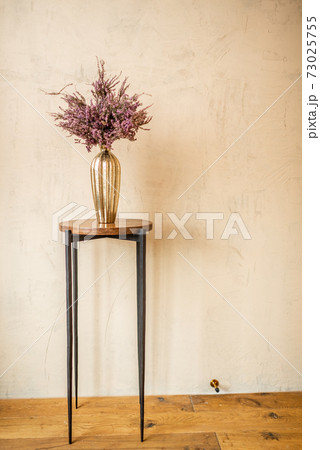 Dried Calluna flower in a gold vase 73025755