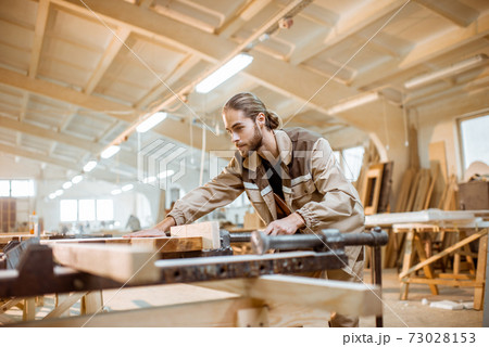 Carpenter working at the carpentry manufacturing Carpenter working at the carpentry manufacturing 73028153